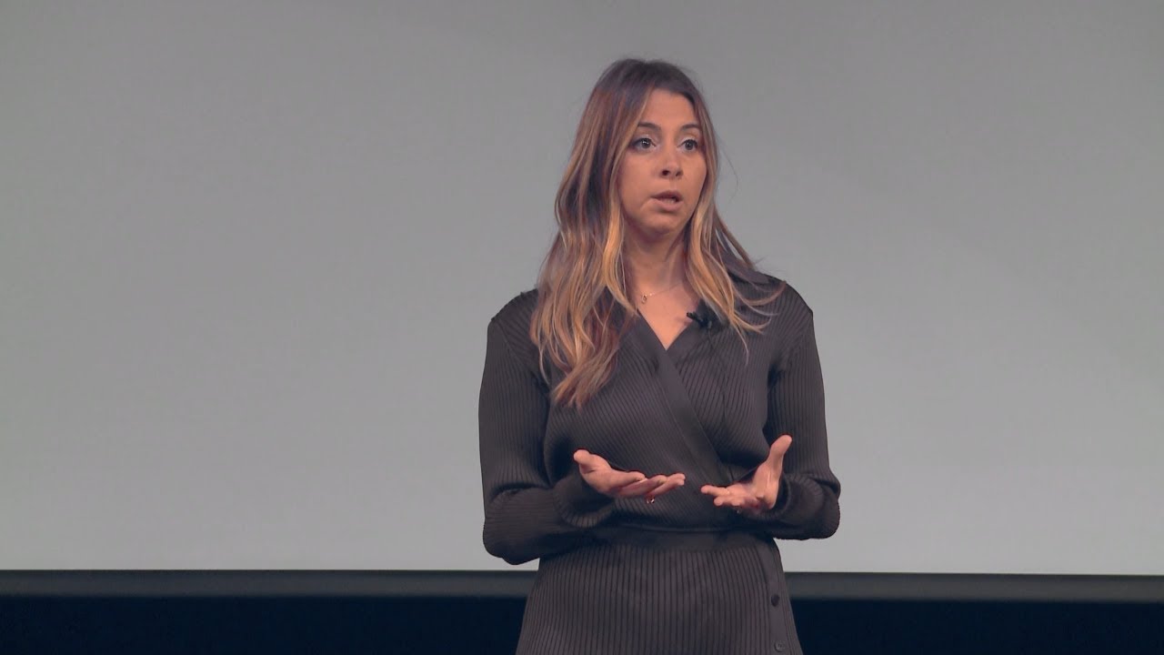 Dr. Nicole Pensak speaking onstage